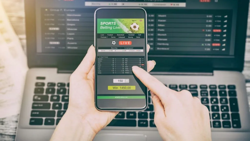 Sports betting interface on a phone and laptop