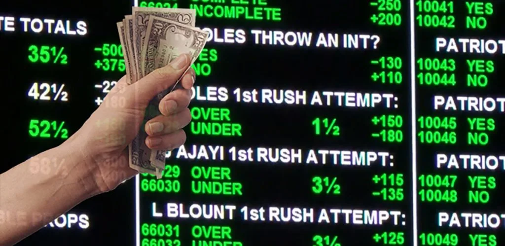 A hand pointing at a betting display